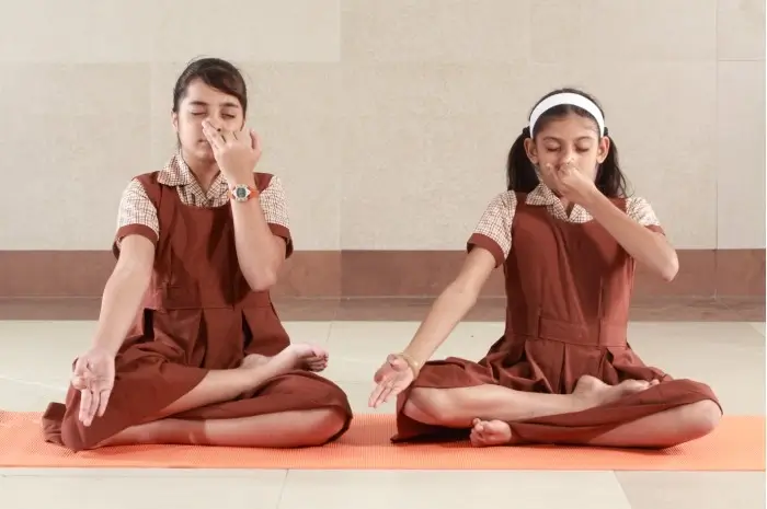 two girl students from MVM school doing yoga